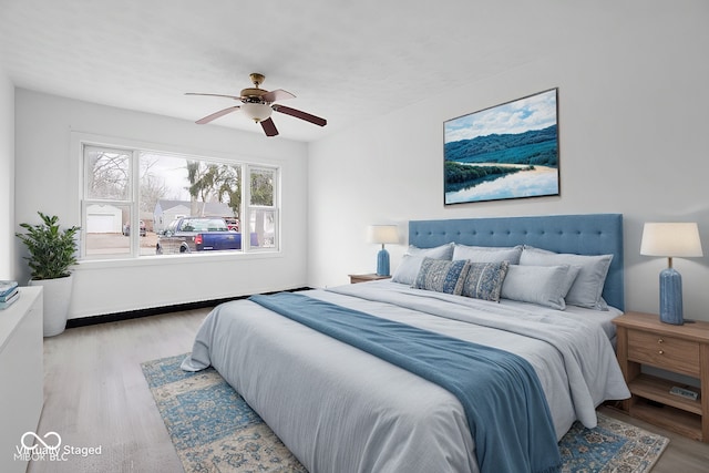 bedroom featuring light hardwood / wood-style flooring and ceiling fan