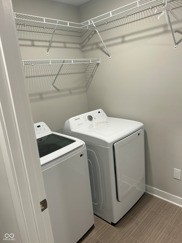 washroom with hardwood / wood-style floors and independent washer and dryer