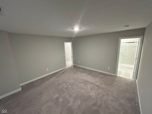 carpeted spare room with a textured ceiling