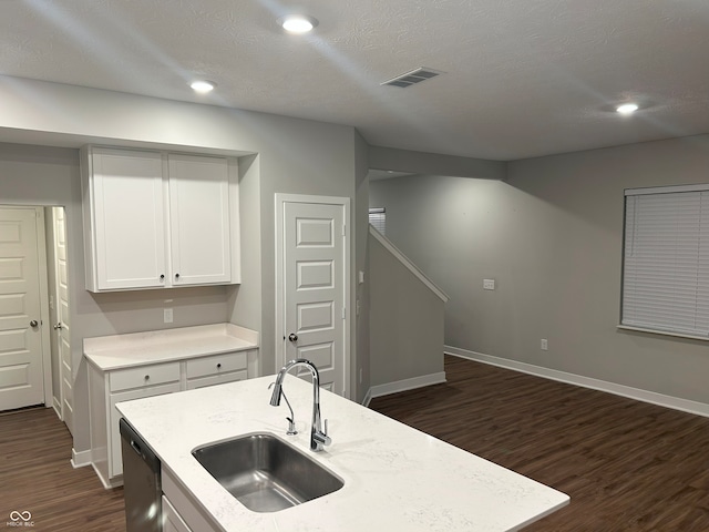 kitchen with dark hardwood / wood-style flooring, white cabinets, sink, a center island with sink, and dishwasher