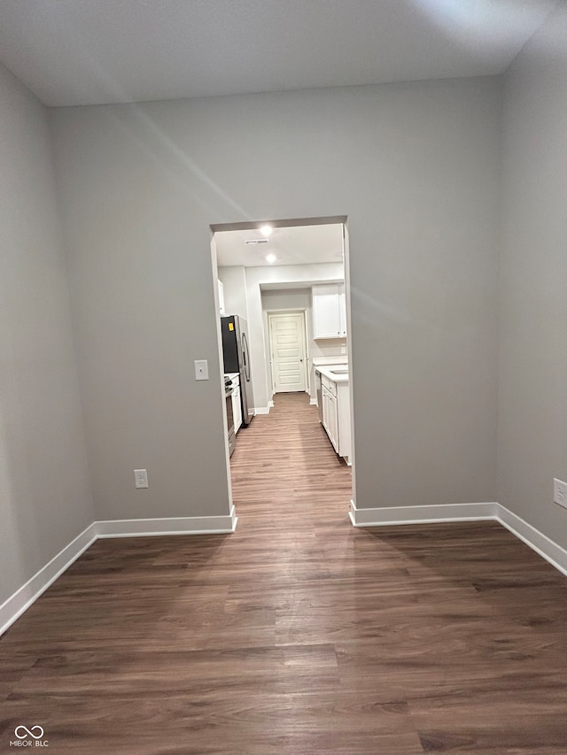 empty room featuring dark hardwood / wood-style flooring