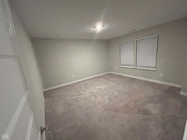 spare room with carpet flooring and a textured ceiling