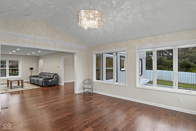 interior space with dark hardwood / wood-style flooring, high vaulted ceiling, and an inviting chandelier