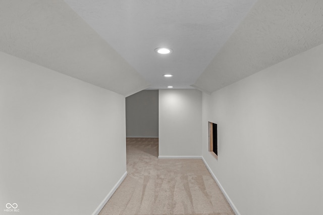 bonus room with light carpet and lofted ceiling