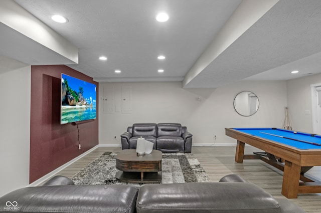 recreation room featuring a textured ceiling, light wood-type flooring, and billiards