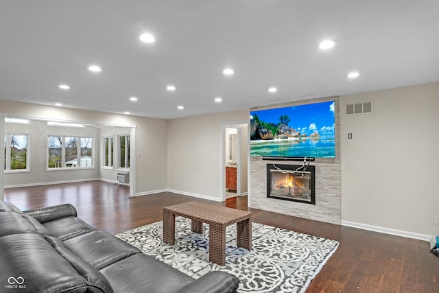 living room featuring a fireplace and dark hardwood / wood-style flooring