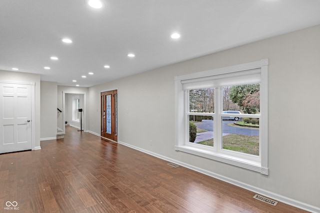 unfurnished room with dark wood-type flooring