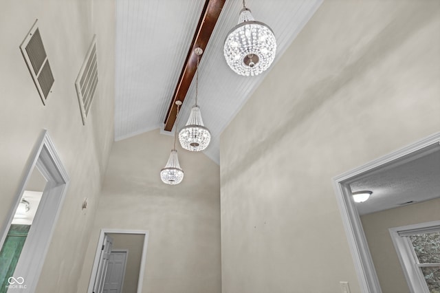 room details with beam ceiling and a chandelier