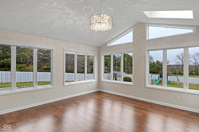 unfurnished sunroom with lofted ceiling with skylight, a healthy amount of sunlight, and a notable chandelier