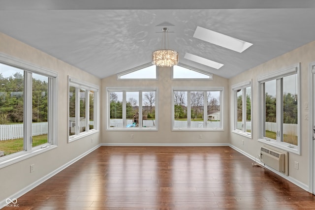 unfurnished sunroom with a wall mounted AC, lofted ceiling with skylight, plenty of natural light, and a chandelier