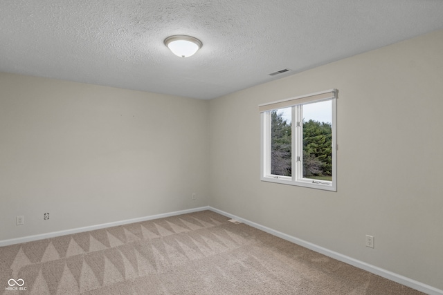 unfurnished room featuring carpet floors and a textured ceiling