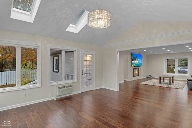 unfurnished living room featuring a notable chandelier, dark hardwood / wood-style flooring, an AC wall unit, and high vaulted ceiling