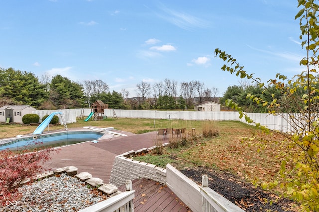 view of yard featuring a playground and a covered pool