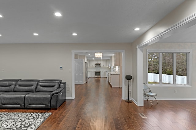 living room with dark hardwood / wood-style floors and sink