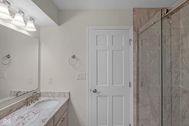 bathroom with vanity and tiled shower