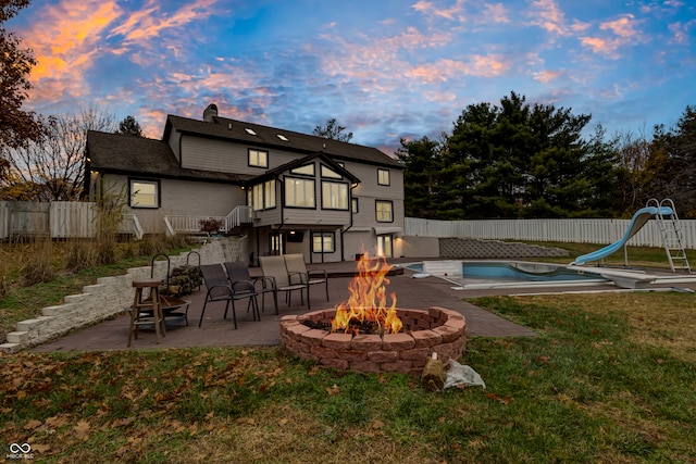 exterior space featuring an outdoor fire pit, a patio area, and a lawn