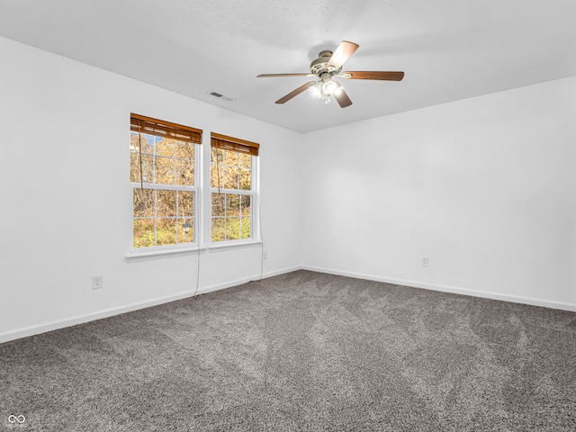 spare room featuring ceiling fan and carpet floors