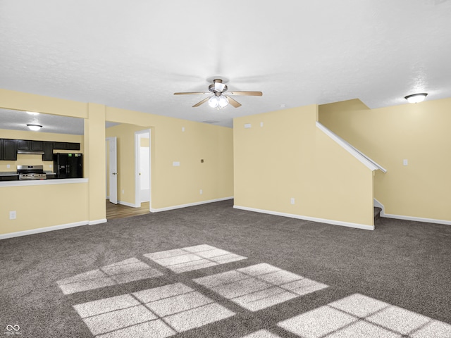 unfurnished living room with dark colored carpet and ceiling fan