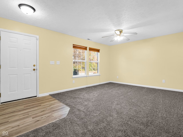 spare room featuring hardwood / wood-style floors, ceiling fan, and a textured ceiling