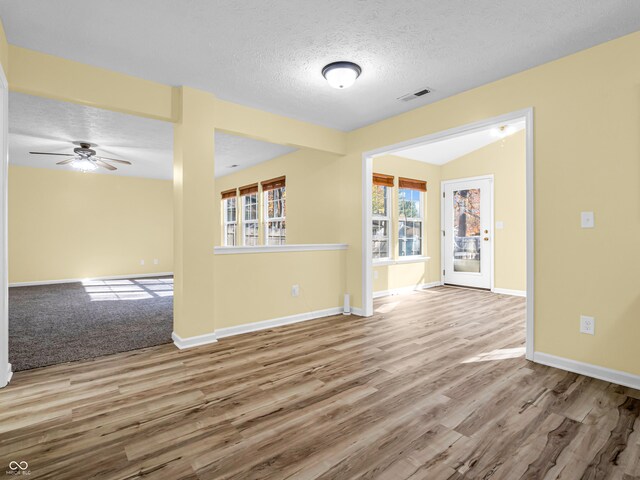 11411 Shady Hollow Ln, Indianapolis, IN 46229 - spare room with wood finished floors, baseboards, a ceiling fan, and a textured ceiling