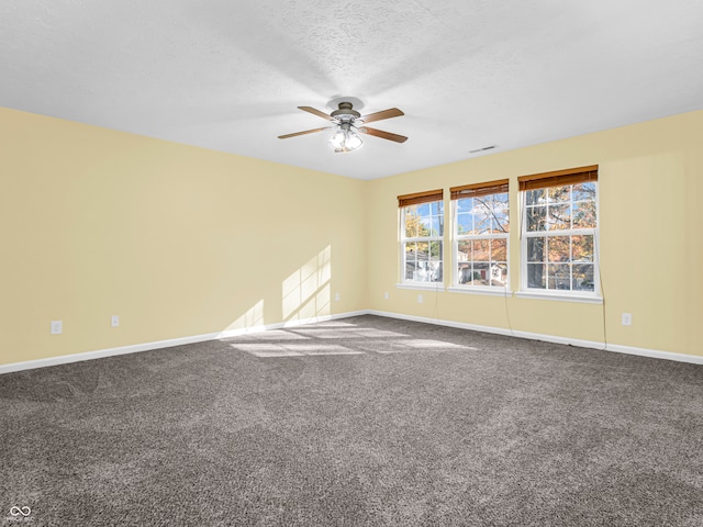 spare room with carpet, a textured ceiling, and ceiling fan