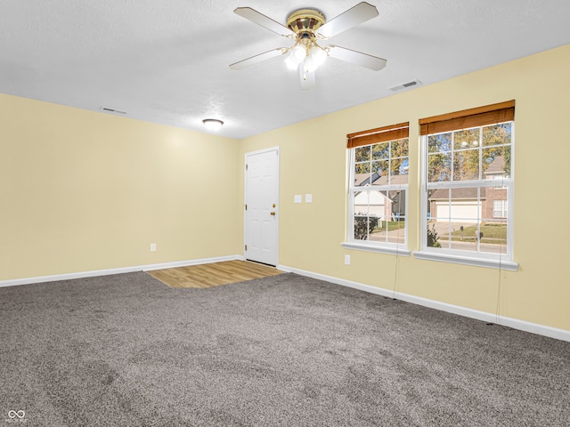 unfurnished room featuring carpet, a textured ceiling, and ceiling fan