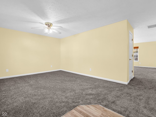 spare room featuring carpet flooring, ceiling fan, and a textured ceiling