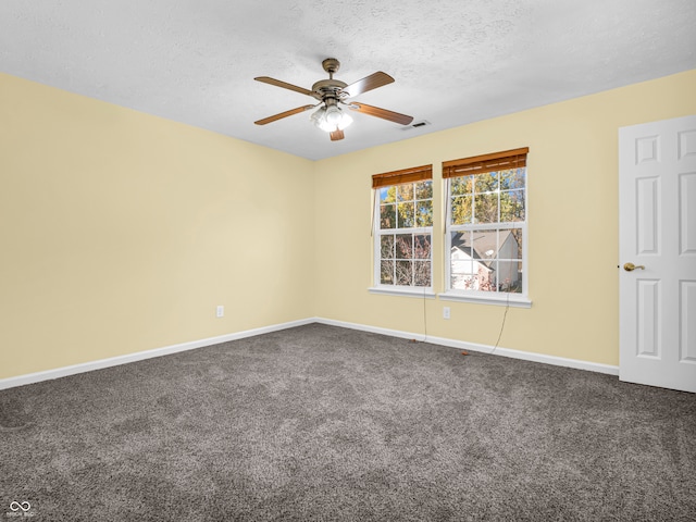 empty room with a textured ceiling, carpet floors, and ceiling fan