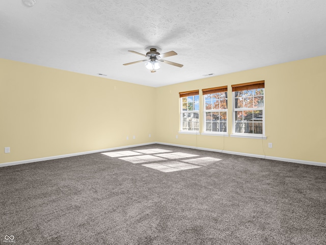 empty room featuring carpet flooring, ceiling fan, and a textured ceiling