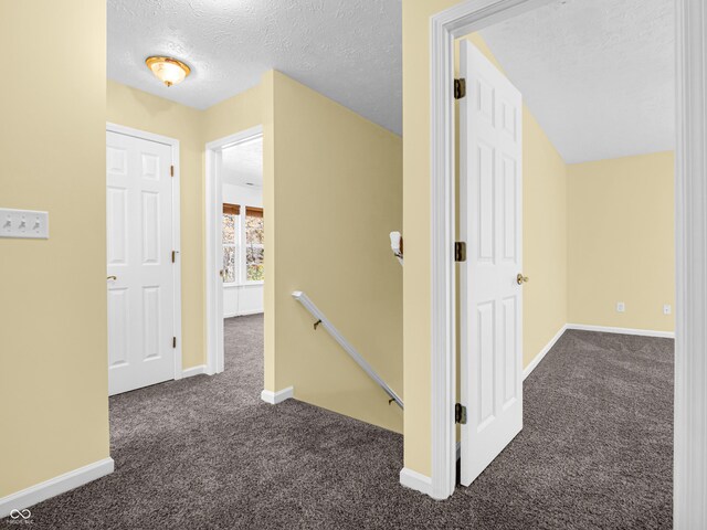11411 Shady Hollow Ln, Indianapolis, IN 46229 - corridor featuring an upstairs landing, carpet flooring, a textured ceiling, and baseboards