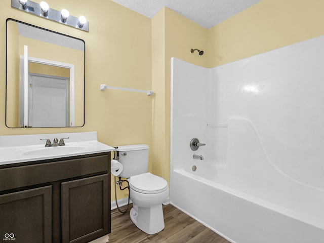 11411 Shady Hollow Ln, Indianapolis, IN 46229 - full bathroom featuring toilet, wood finished floors, vanity, and shower / tub combination