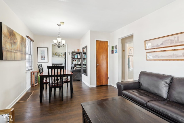 living room featuring dark hardwood / wood-style flooring and a chandelier