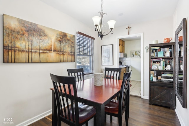 dining room featuring dark hardwood / wood-style flooring and an inviting chandelier