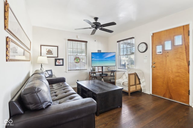 living room featuring dark hardwood / wood-style flooring and ceiling fan