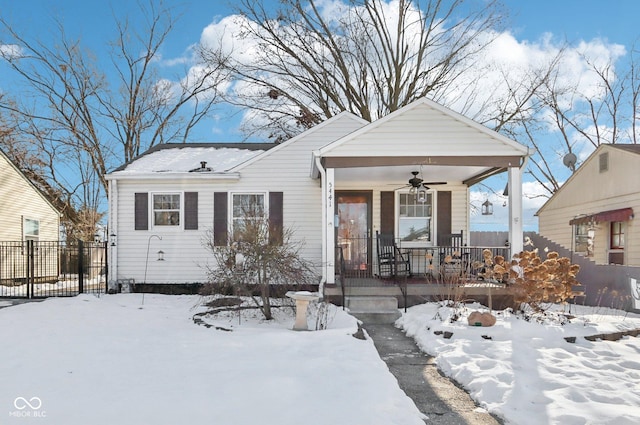 view of front of house featuring a porch, fence, and a ceiling fan