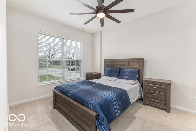 bedroom with light colored carpet and ceiling fan