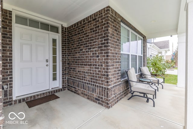 view of exterior entry featuring covered porch