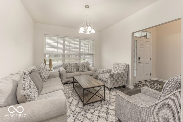 living room featuring a chandelier and wood-type flooring