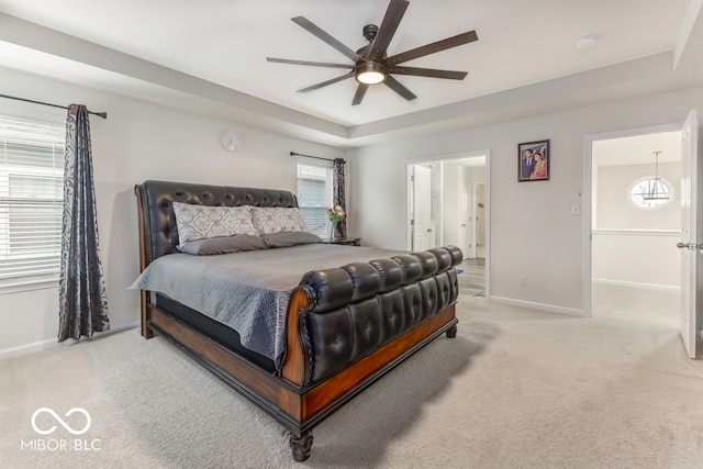 carpeted bedroom with ceiling fan and ensuite bathroom