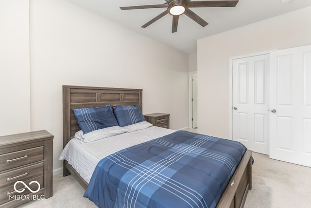 carpeted bedroom with ceiling fan and a closet