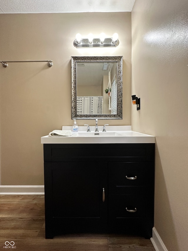 bathroom with vanity and wood-type flooring