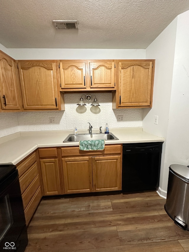 kitchen featuring sink, dark hardwood / wood-style floors, tasteful backsplash, and black appliances