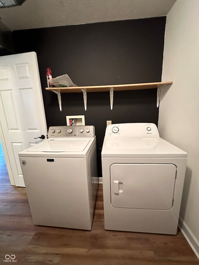 washroom with hardwood / wood-style floors and washer and clothes dryer