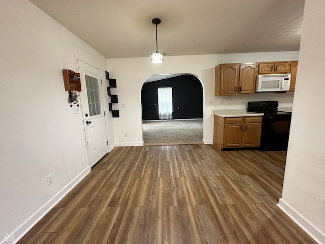 kitchen with hanging light fixtures, black / electric stove, and dark wood-type flooring