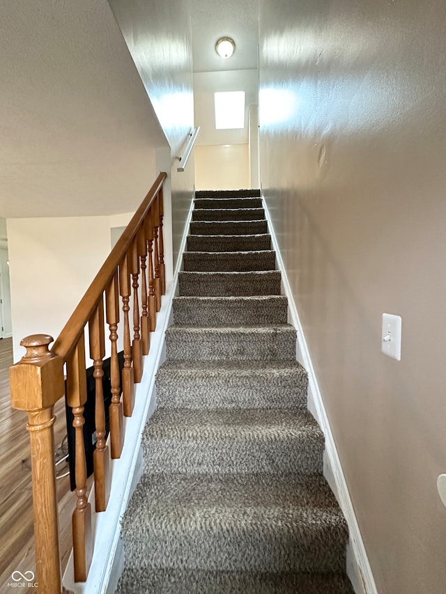 staircase featuring hardwood / wood-style flooring