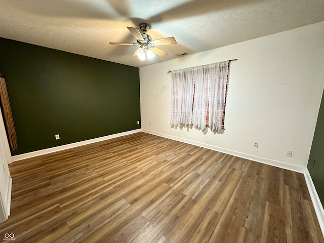 spare room with a textured ceiling, hardwood / wood-style flooring, and ceiling fan