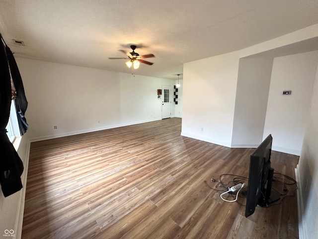 unfurnished living room with hardwood / wood-style floors and ceiling fan