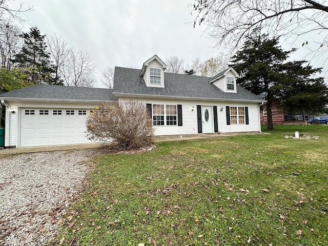 new england style home featuring a garage and a front yard