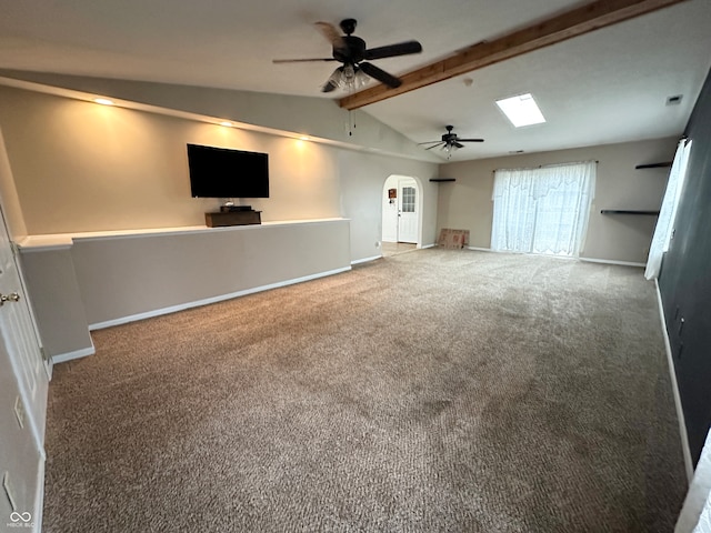 unfurnished living room with carpet, lofted ceiling with beams, and ceiling fan