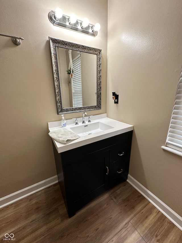 bathroom with vanity and hardwood / wood-style flooring